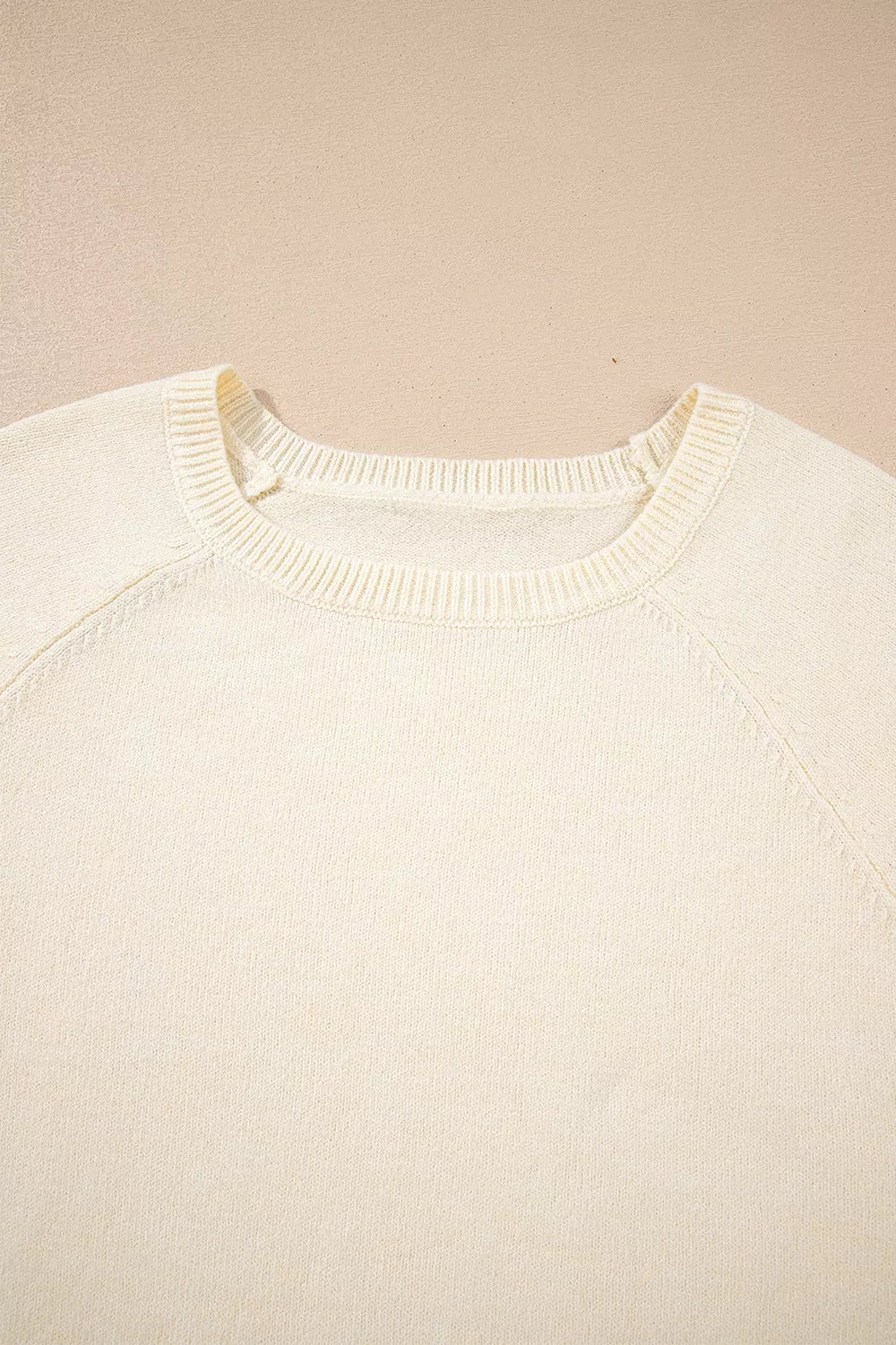 Button-cuff raglan sleeve crew neck sweater