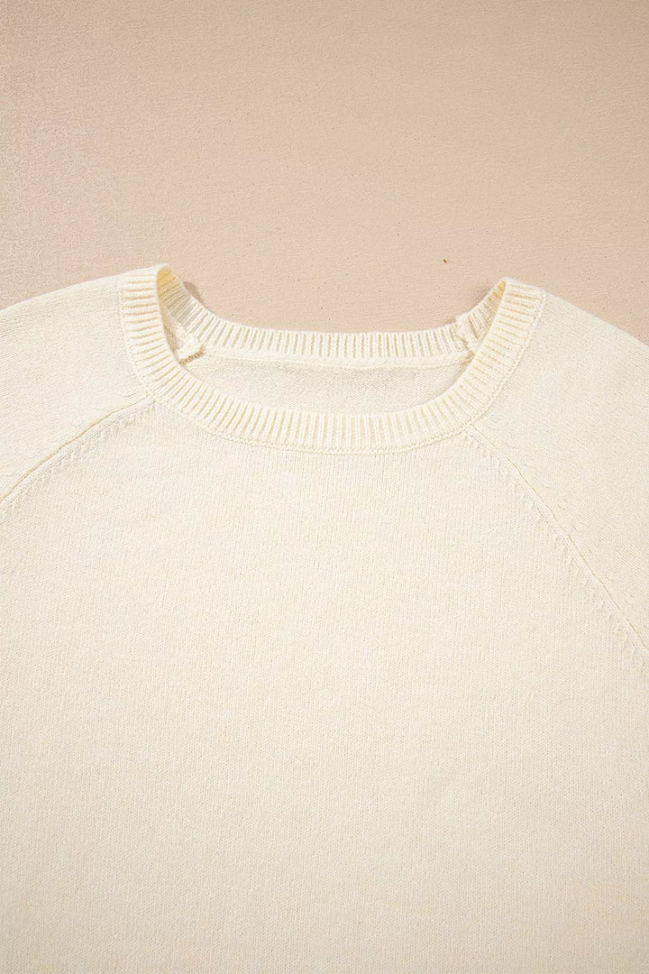 Button-cuff raglan sleeve crew neck sweater