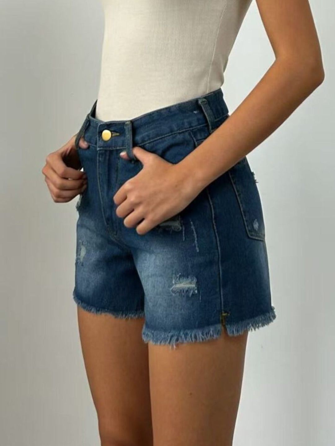 Distressed high-rise denim shorts with frayed raw hem
