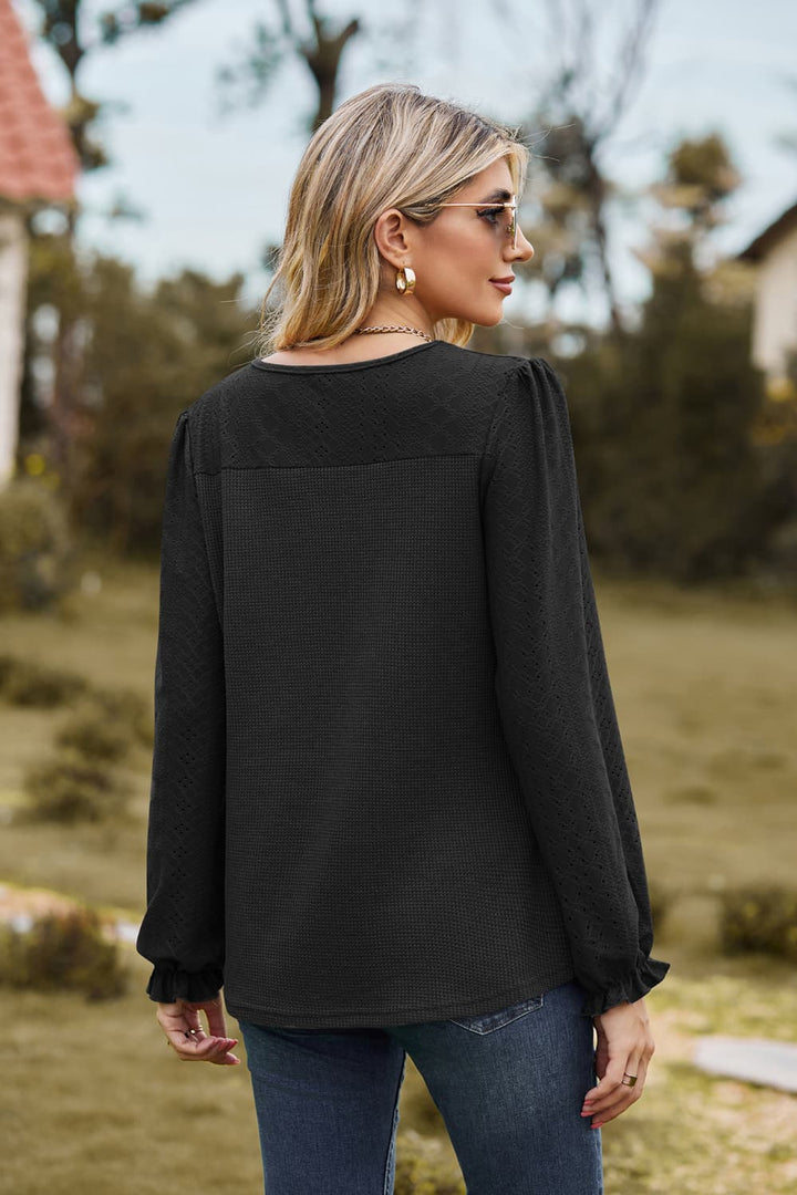 Eyelet knit puff sleeve blouse with round neckline