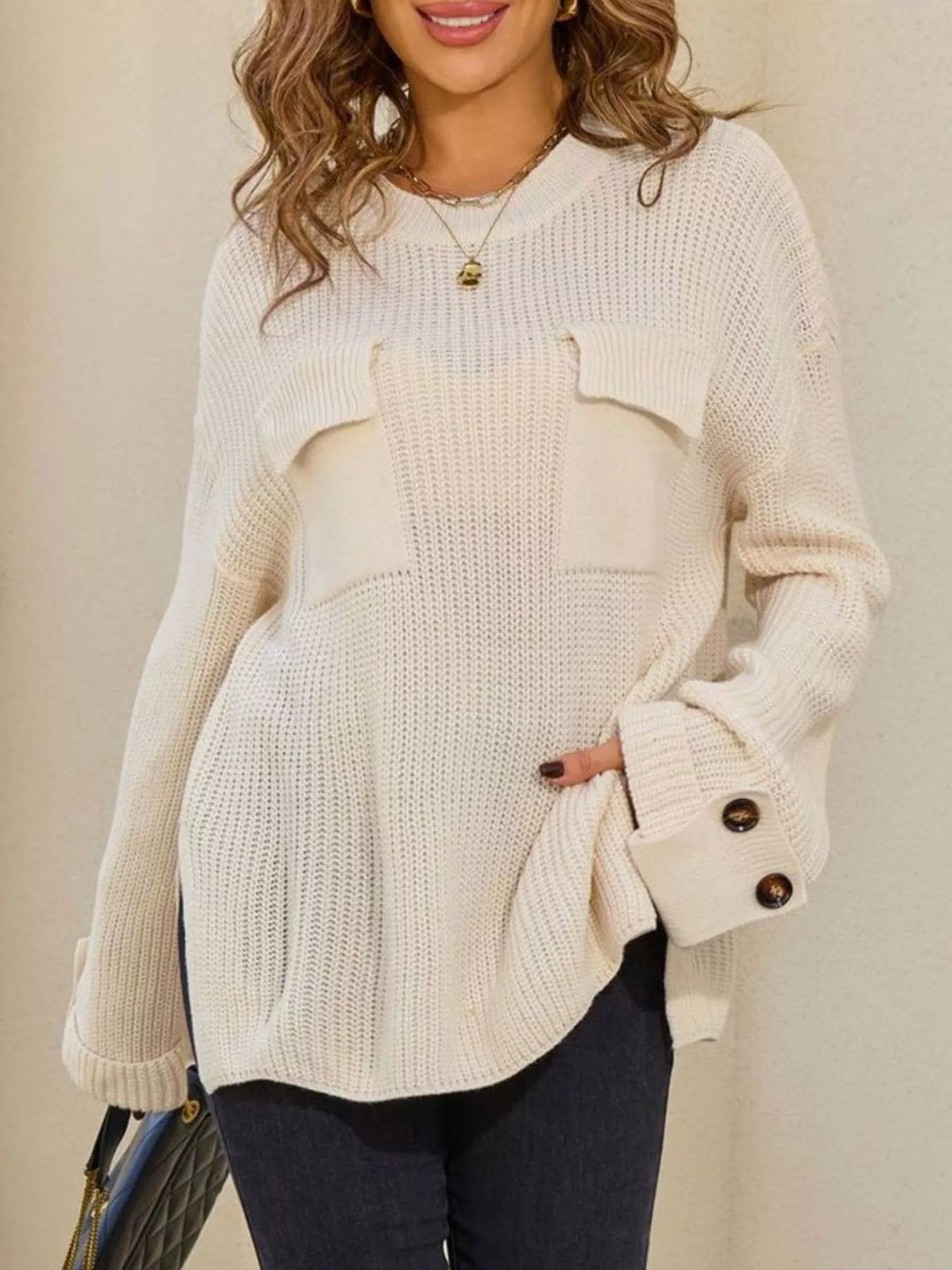 Ribbed knit sweater with chest pockets and button cuffs