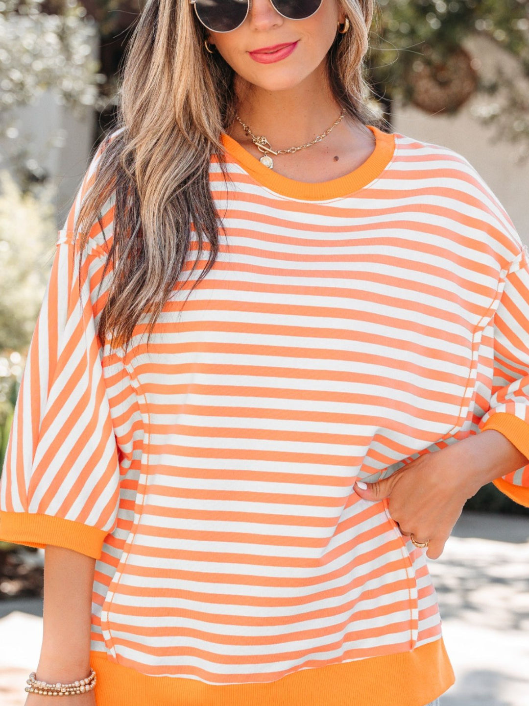 Striped exposed-seam 3/4 sleeve pullover top