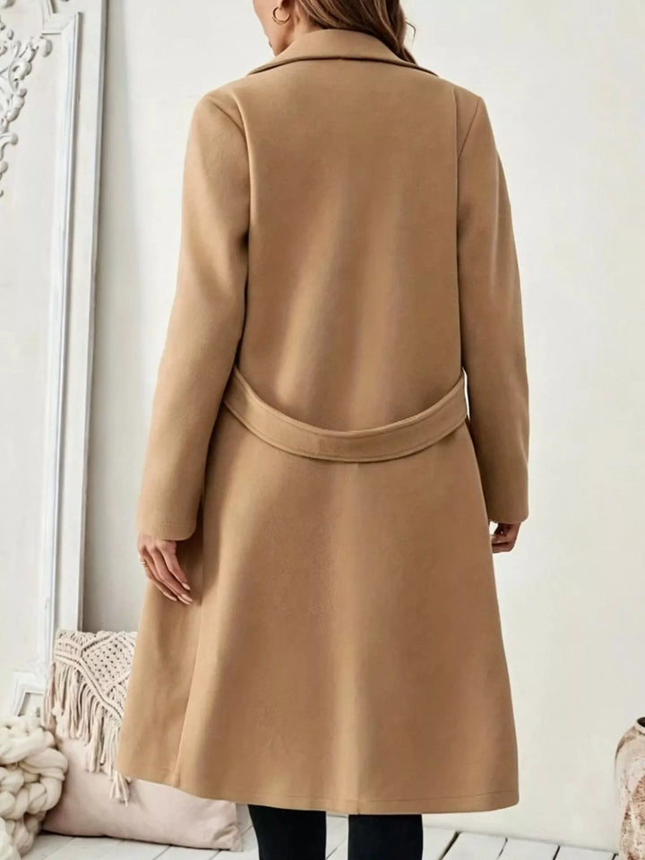 Longline notch lapel coat with single-button waist tab