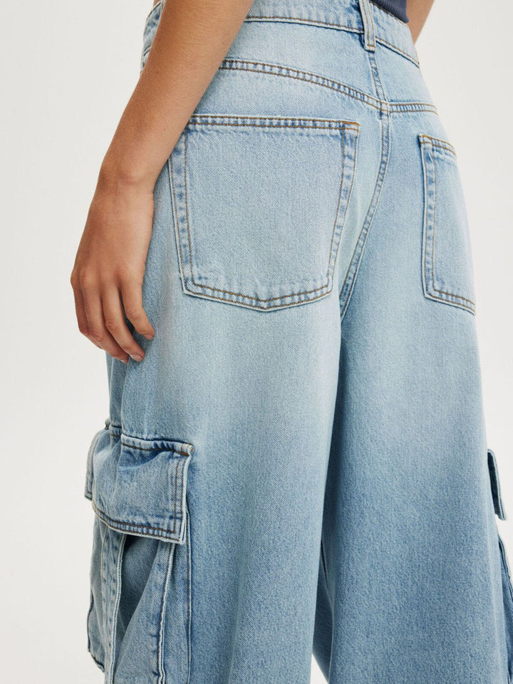 Vintage wash wide-leg cargo jeans with strap pockets