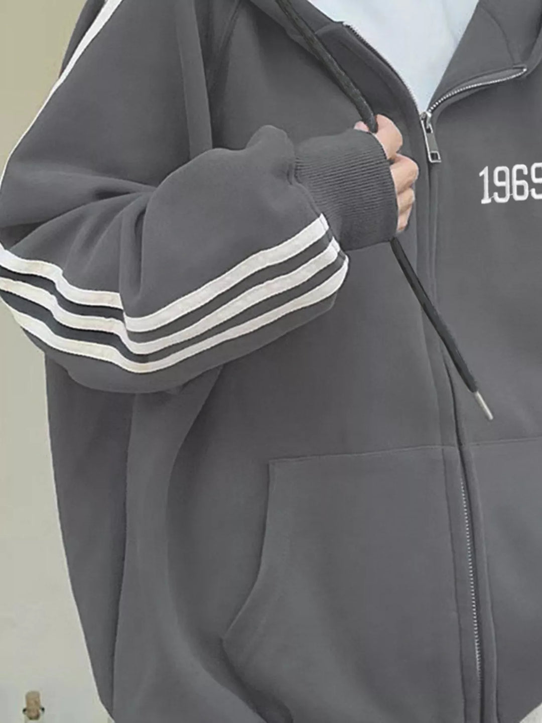 Oversized zip-up hoodie with striped sleeves and drawstring hood