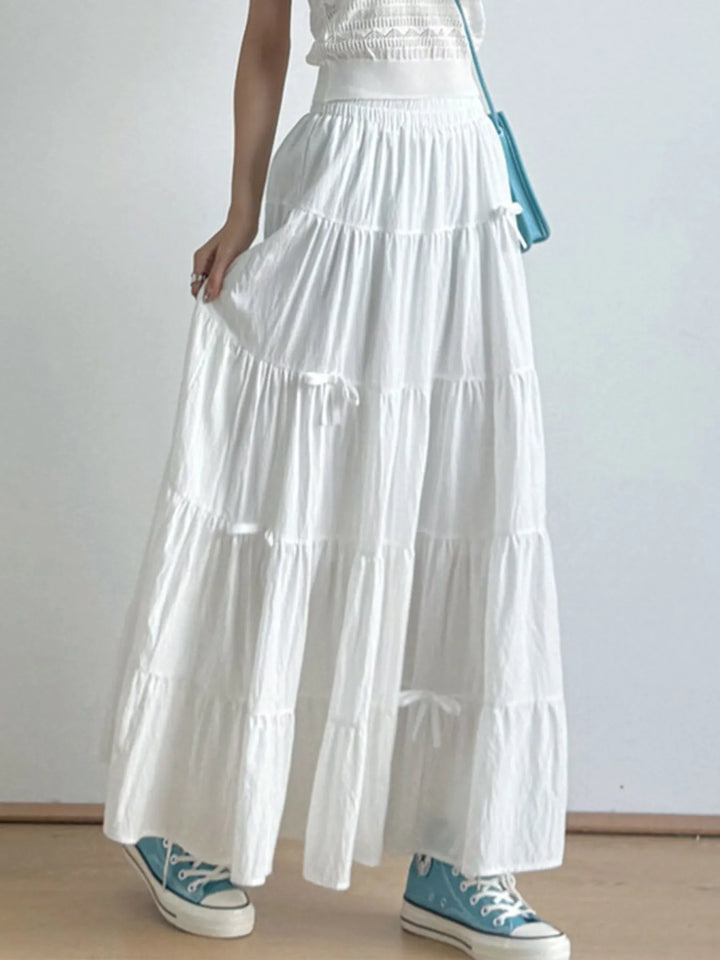 Tiered bow-accent maxi skirt with elastic smocked waist