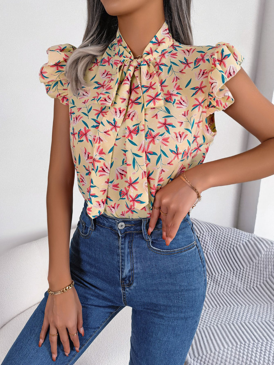 Floral tie-neck blouse with ruffled flutter sleeves
