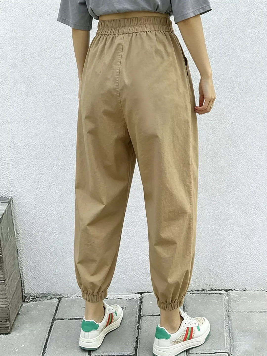 Pleated harem pants with elastic waist and tapered cuffs