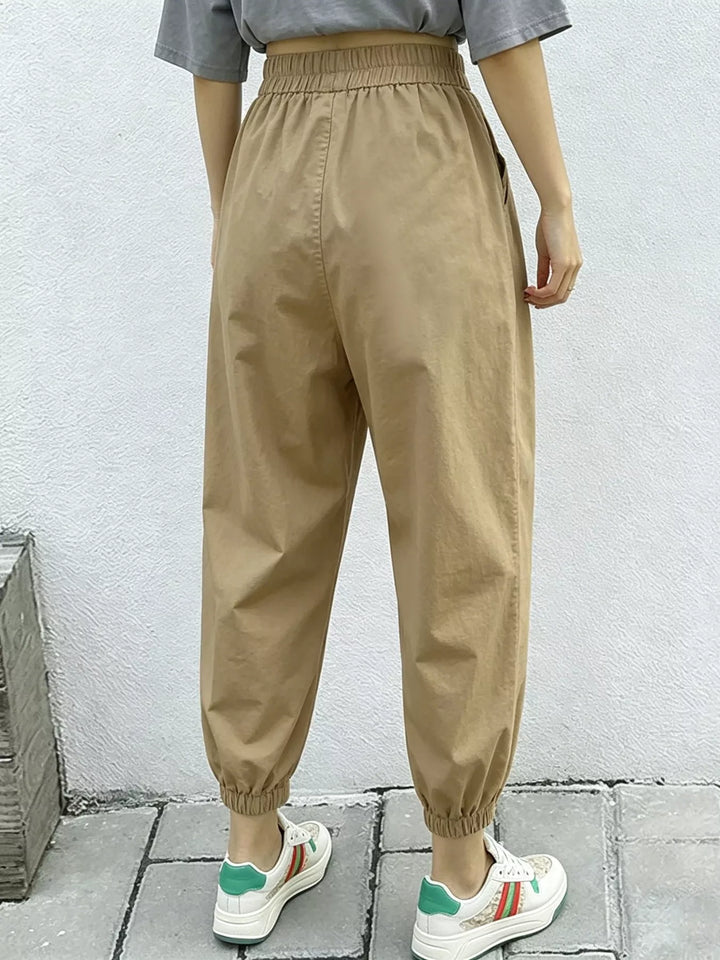 Pleated harem pants with elastic waist and tapered cuffs