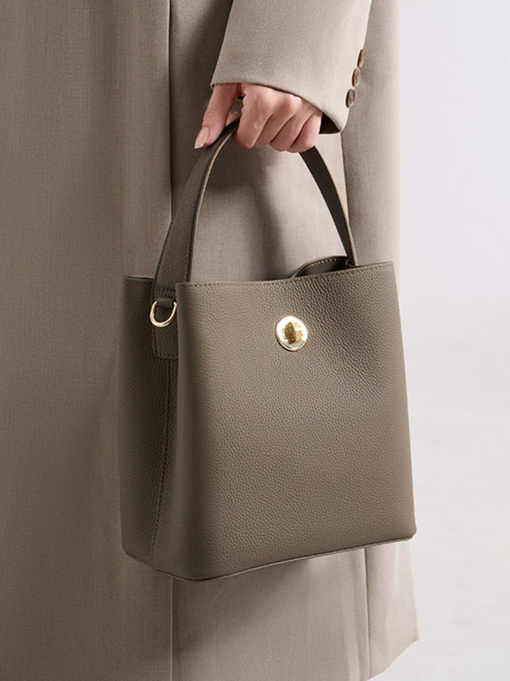 Pebbled faux leather bucket crossbody bag with twist lock