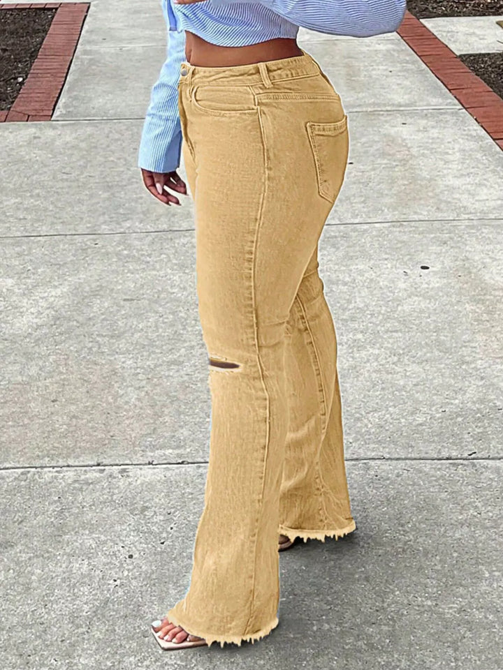 High-rise ripped knee flare jeans with raw hem