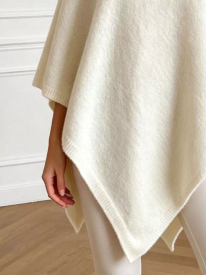 Asymmetrical hem textured knit poncho with ribbed crew neck
