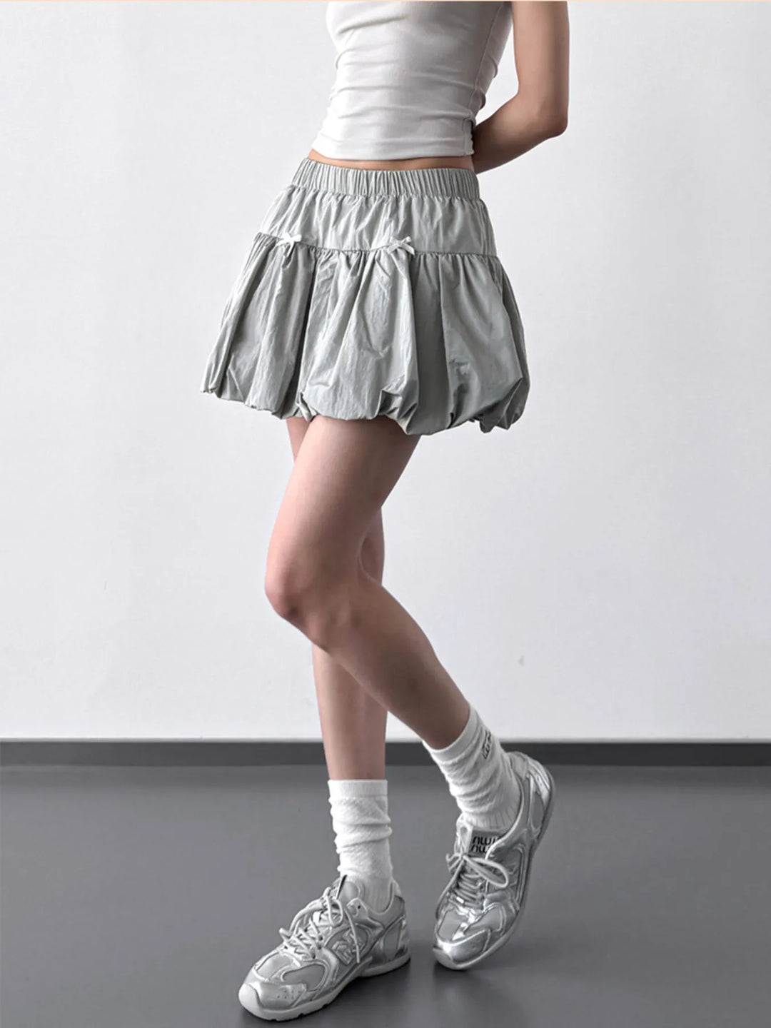 Bubble hem mini skirt with bow trim and elastic waist