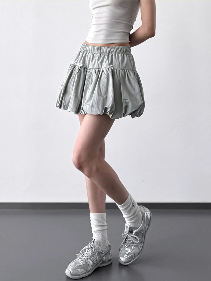 Bubble hem mini skirt with bow trim and elastic waist