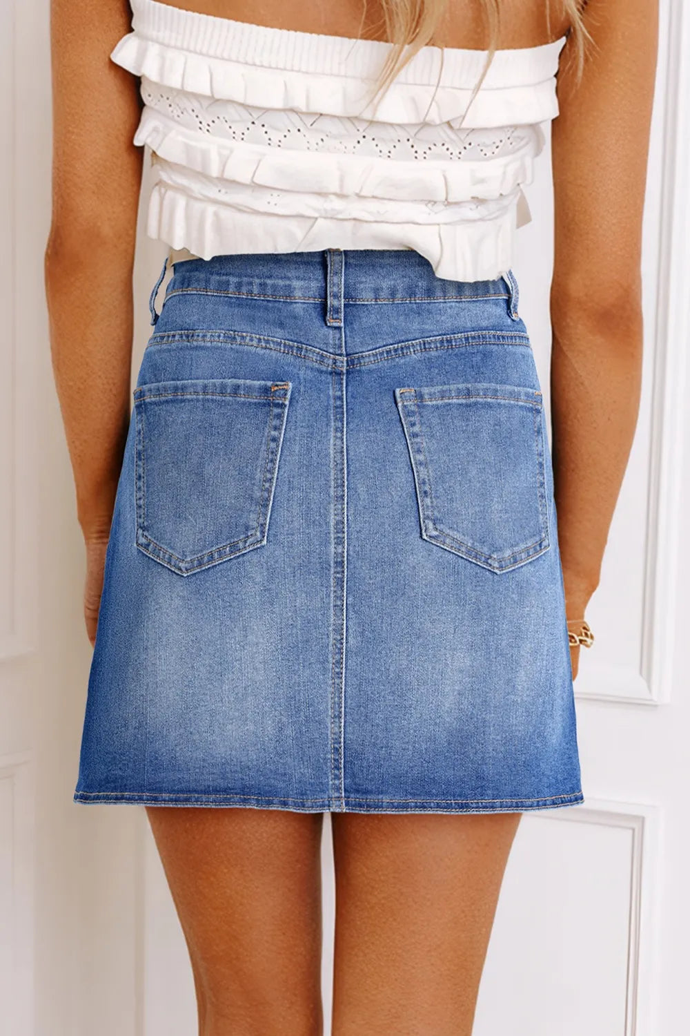 Wrap-front denim mini skirt with angled hem seam