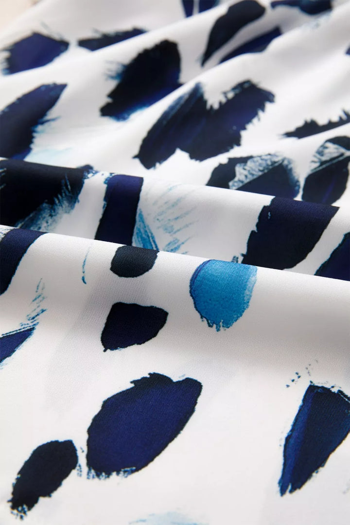 Abstract animal print blouse with striped ruffle yoke