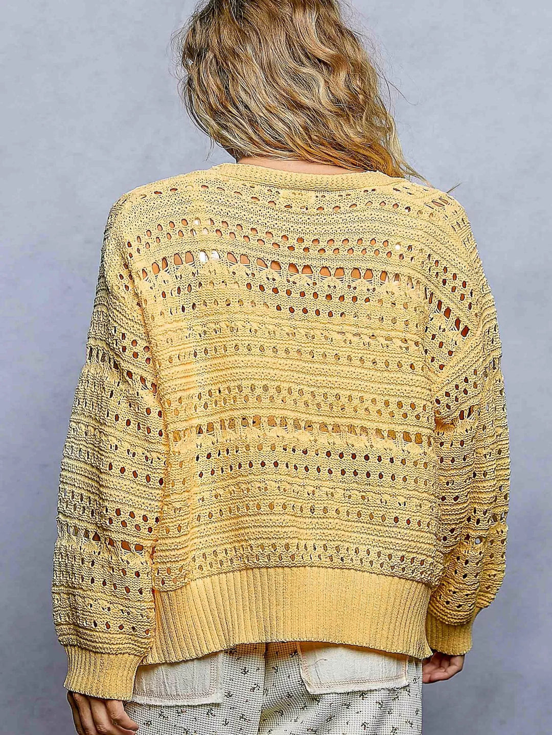 Open-knit V-neck cardigan with 3D floral button closure