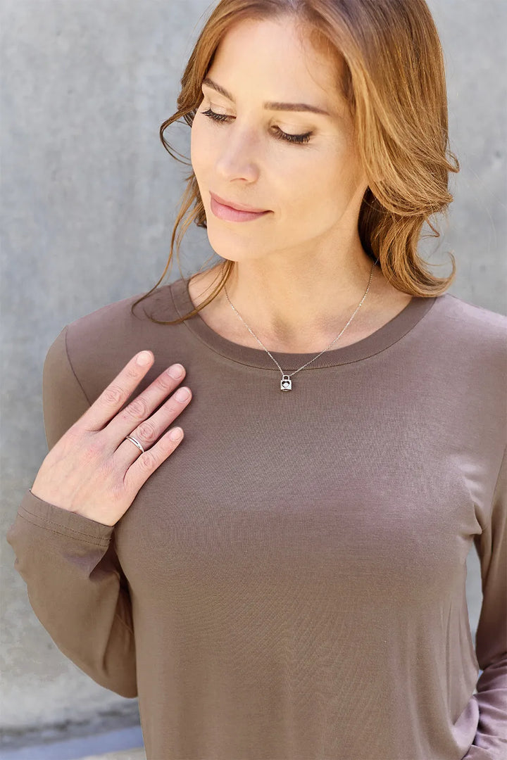 Crew neck long sleeve top with curved hem