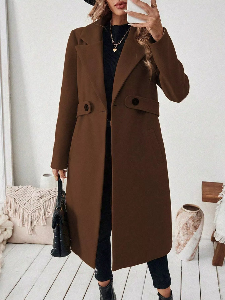 Longline notch lapel coat with single-button waist tab