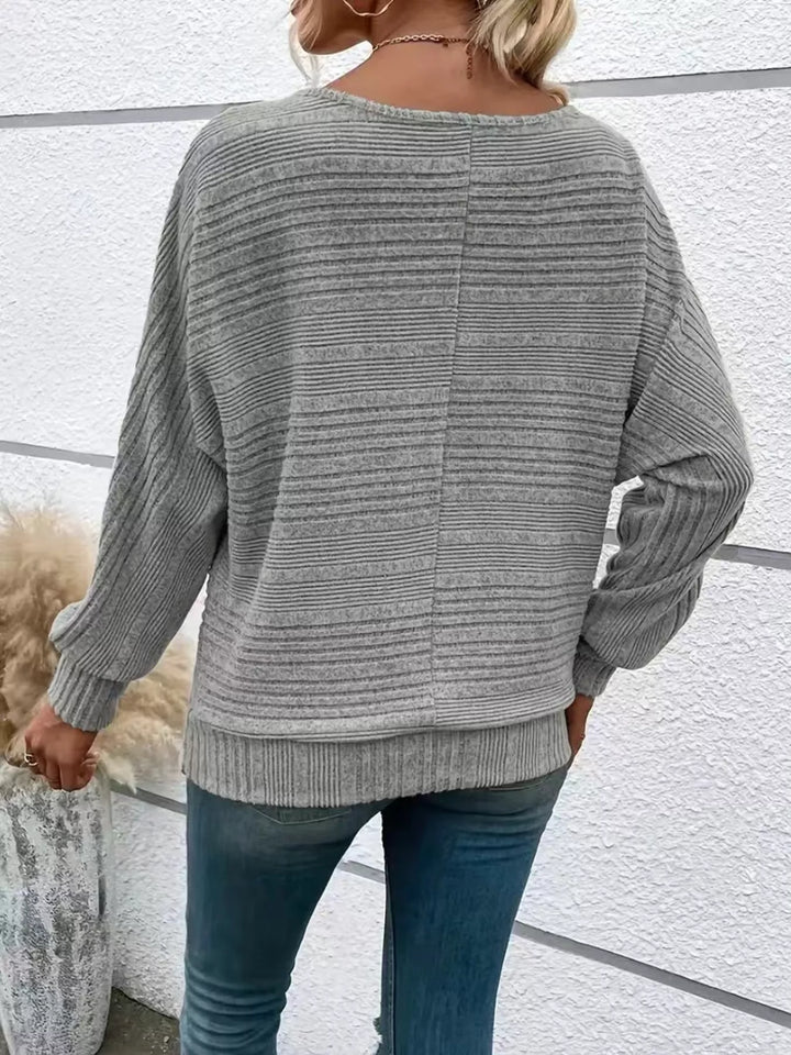 Ribbed knit quarter-zip batwing sweater with O-ring pull