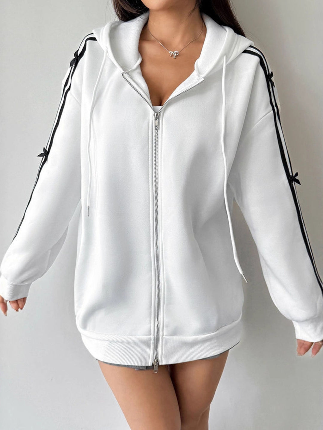 Zip-up hoodie with striped sleeves and bow detail