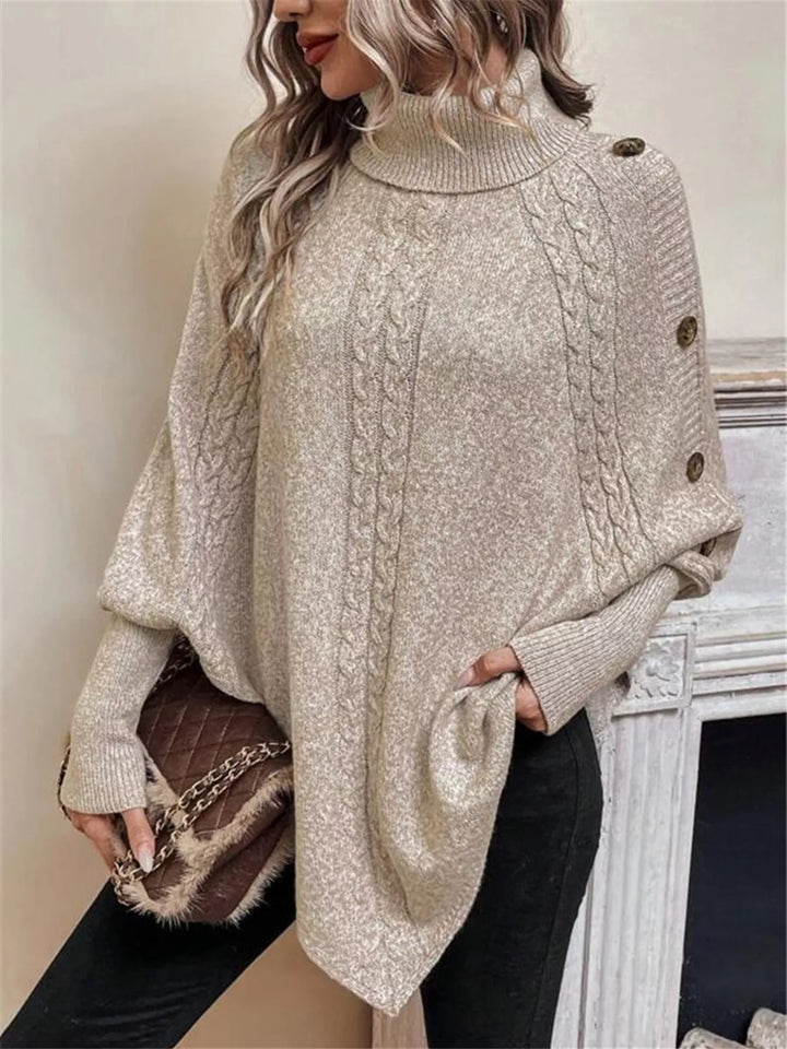 Cable knit turtleneck cape sweater with button shoulder