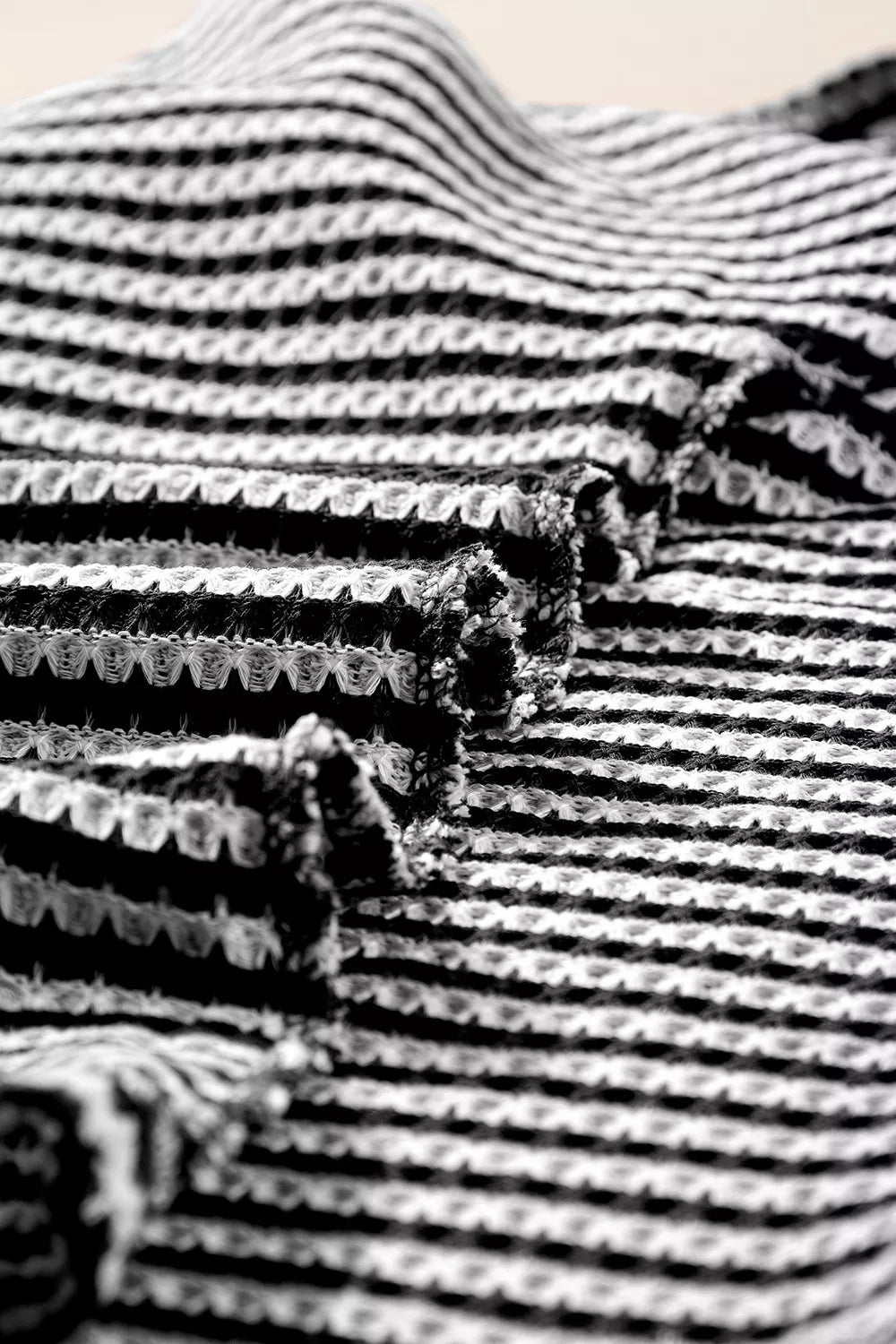 Striped textured knit top with notched V-neck and cuffed sleeves