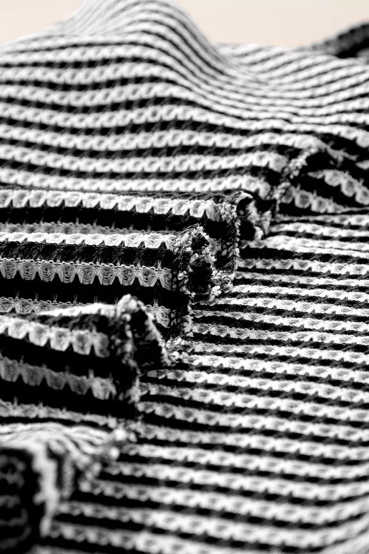 Striped textured knit top with notched V-neck and cuffed sleeves