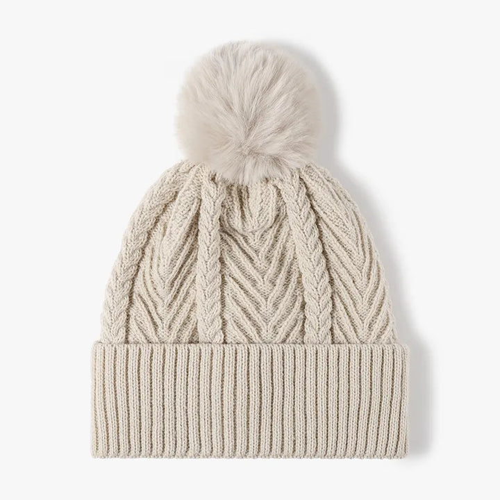 Beige Cable knit beanie with faux fur pompom and ribbed cuff
