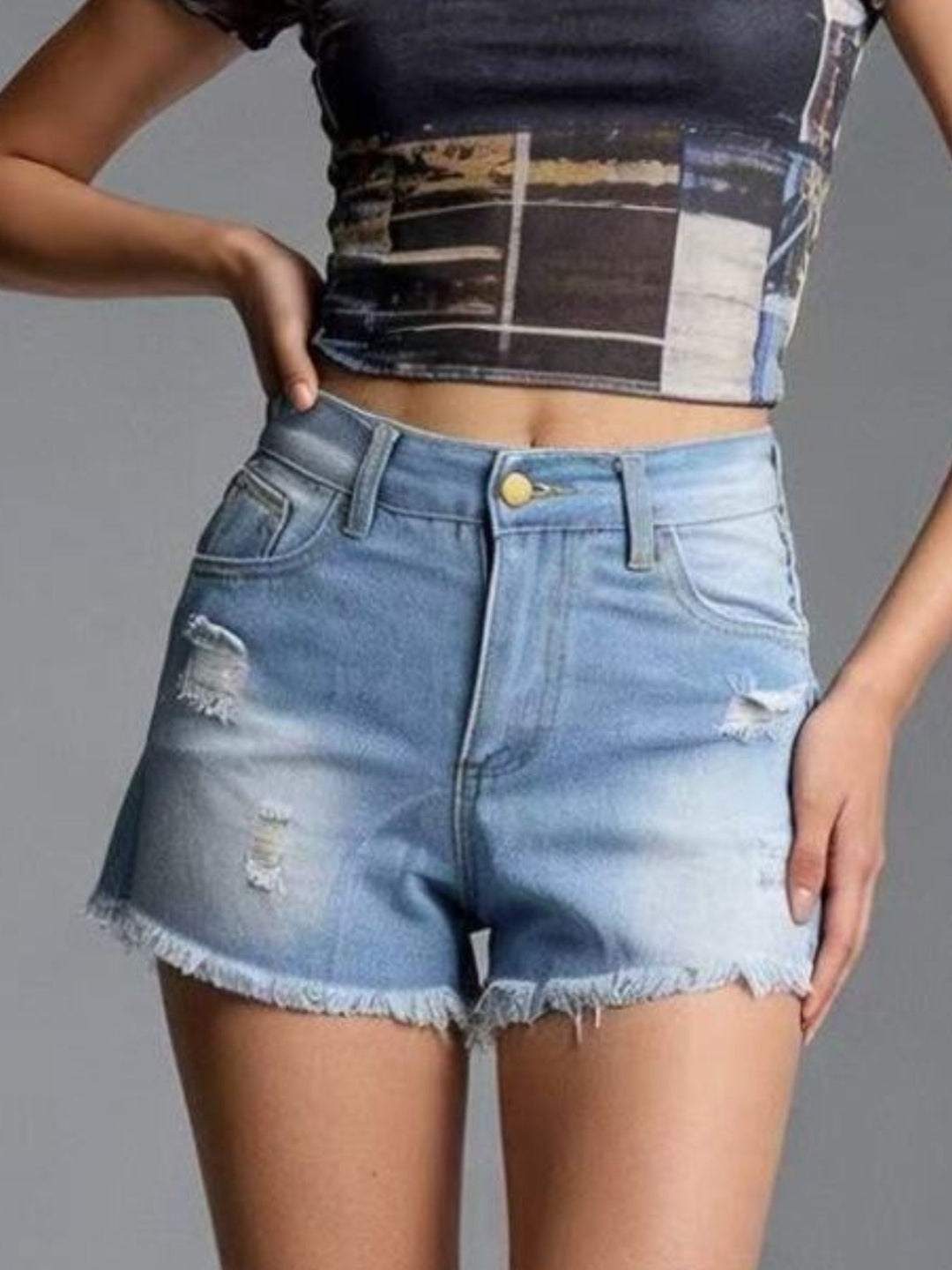 Distressed high-rise denim shorts with frayed raw hem