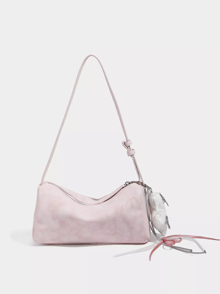 Pink Adjustable strap crossbody bag with heart charm and bow trim