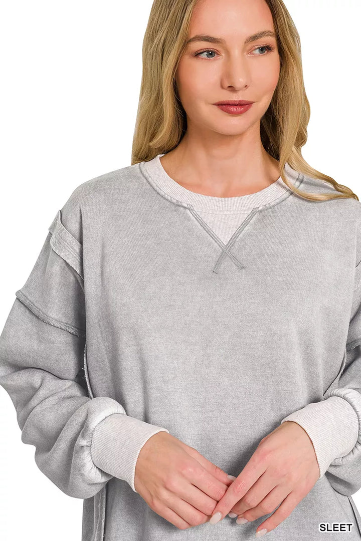 Acid wash fleece pullover with exposed seams and side slits