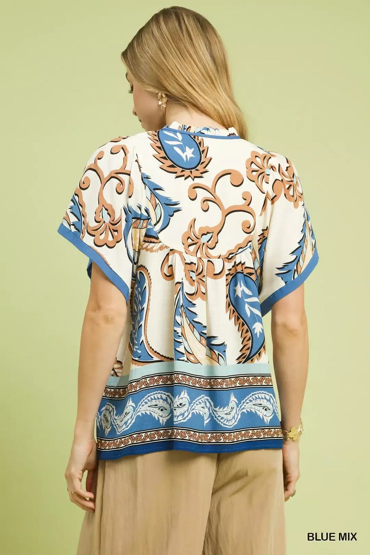 Relaxed paisley border print top with tassel tie neckline