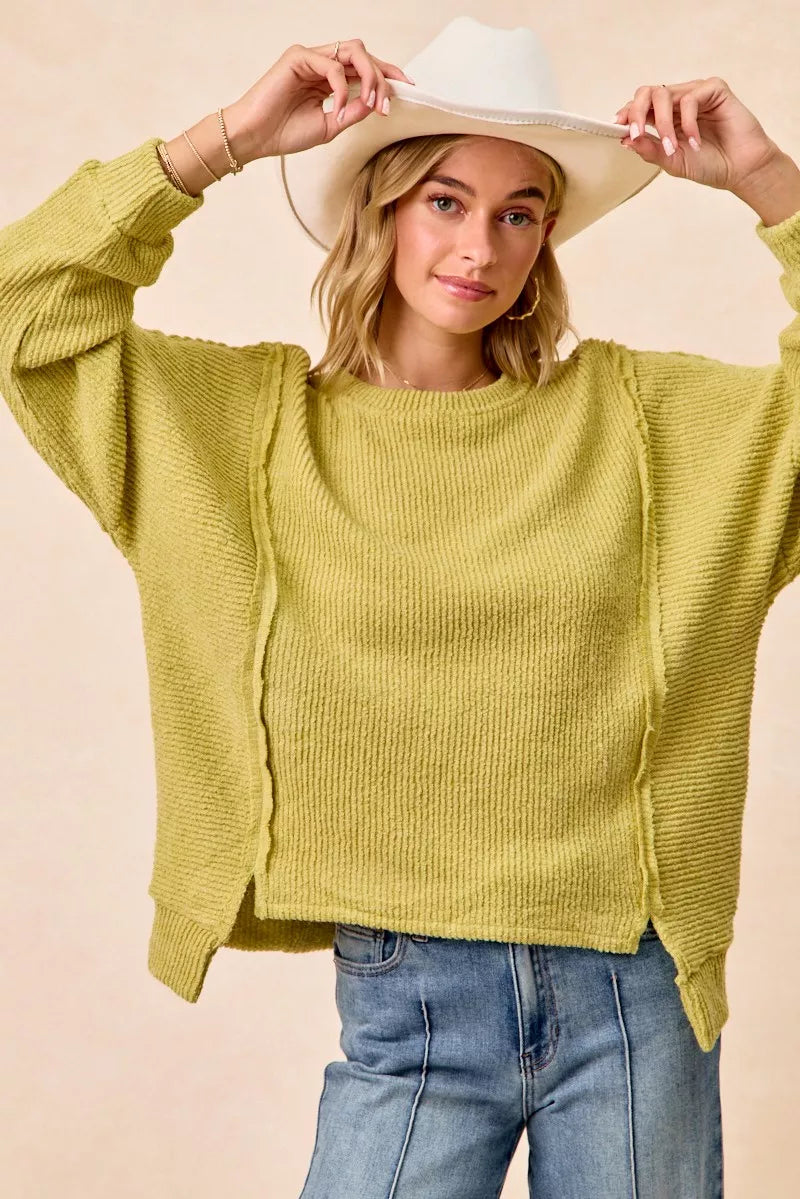 LIME Ribbed boucle knit sweater with exposed seams and uneven hem