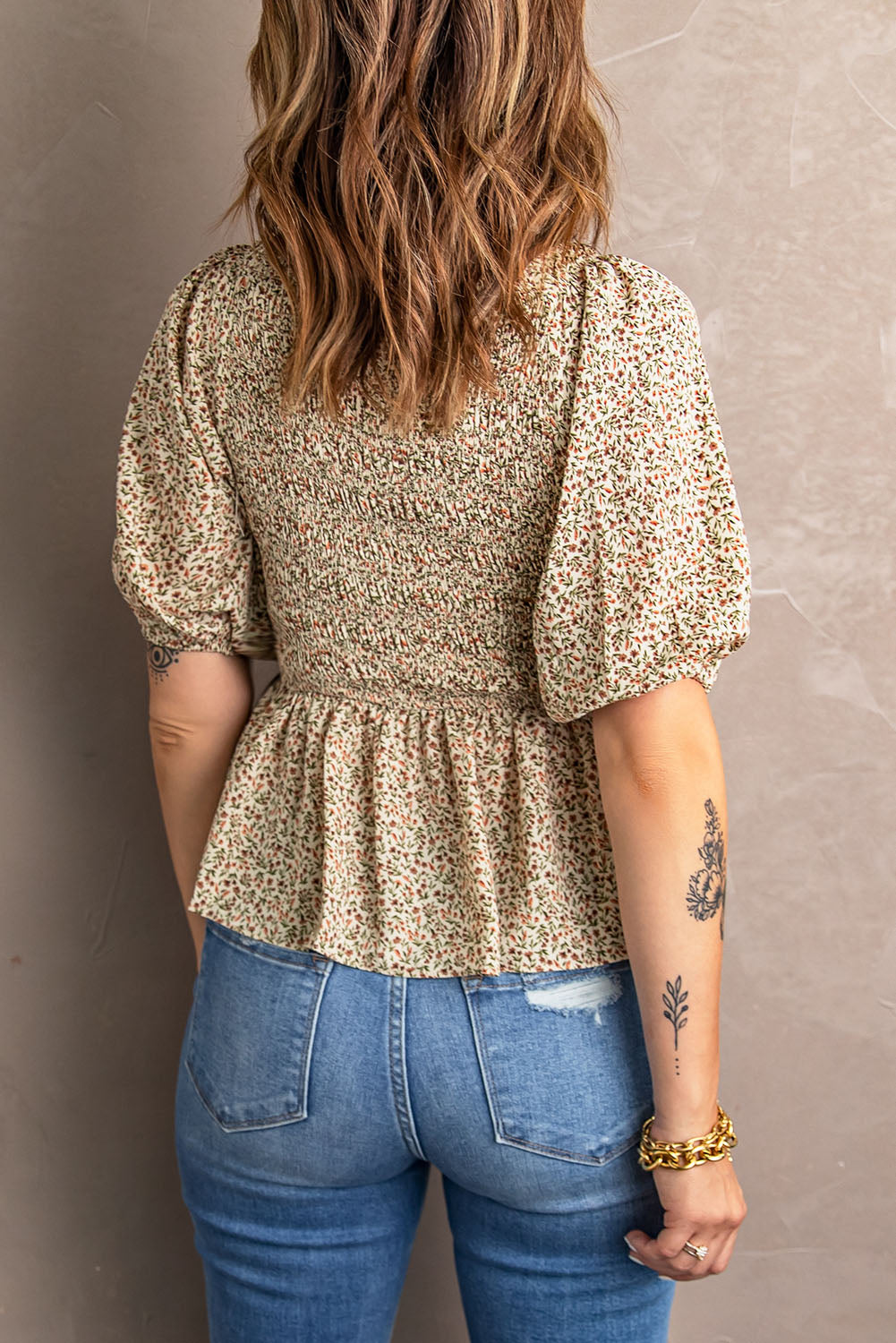 Smocked peplum blouse with balloon sleeves and V-neck