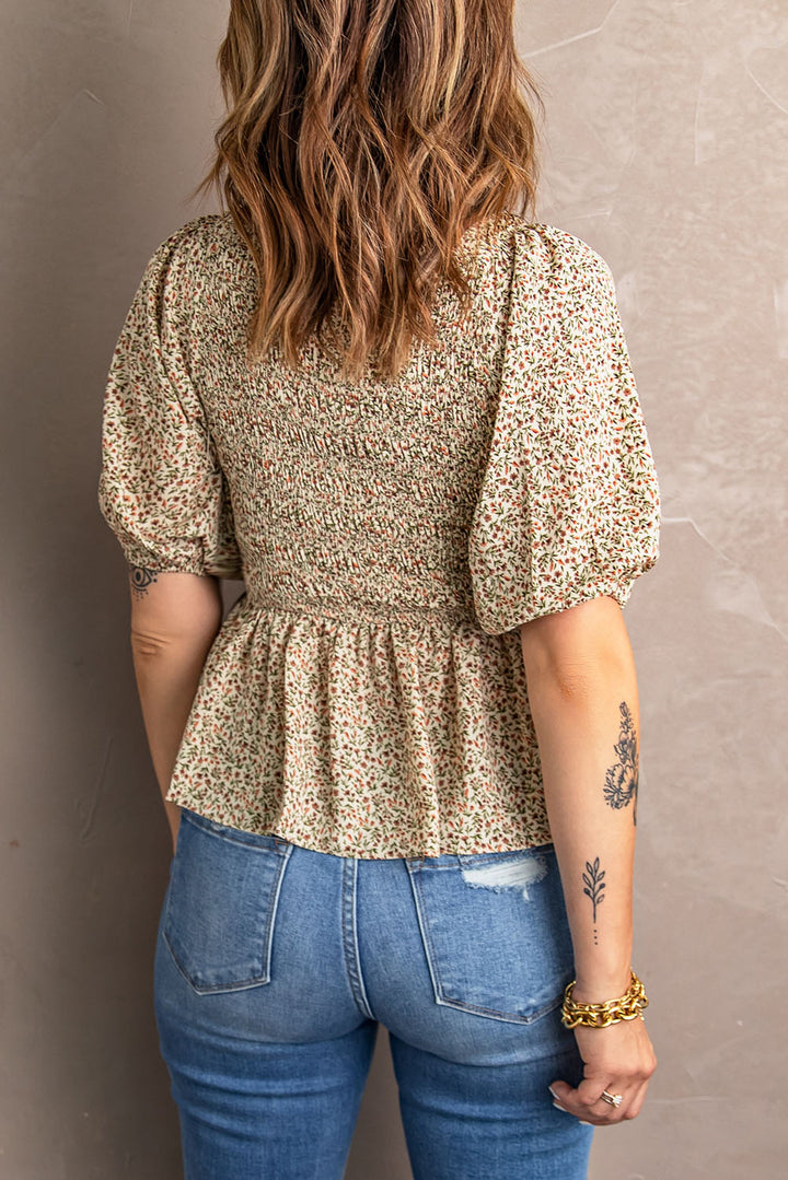 Smocked peplum blouse with balloon sleeves and V-neck