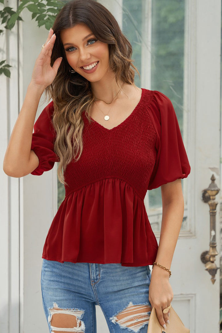 Smocked peplum blouse with balloon sleeves and V-neck