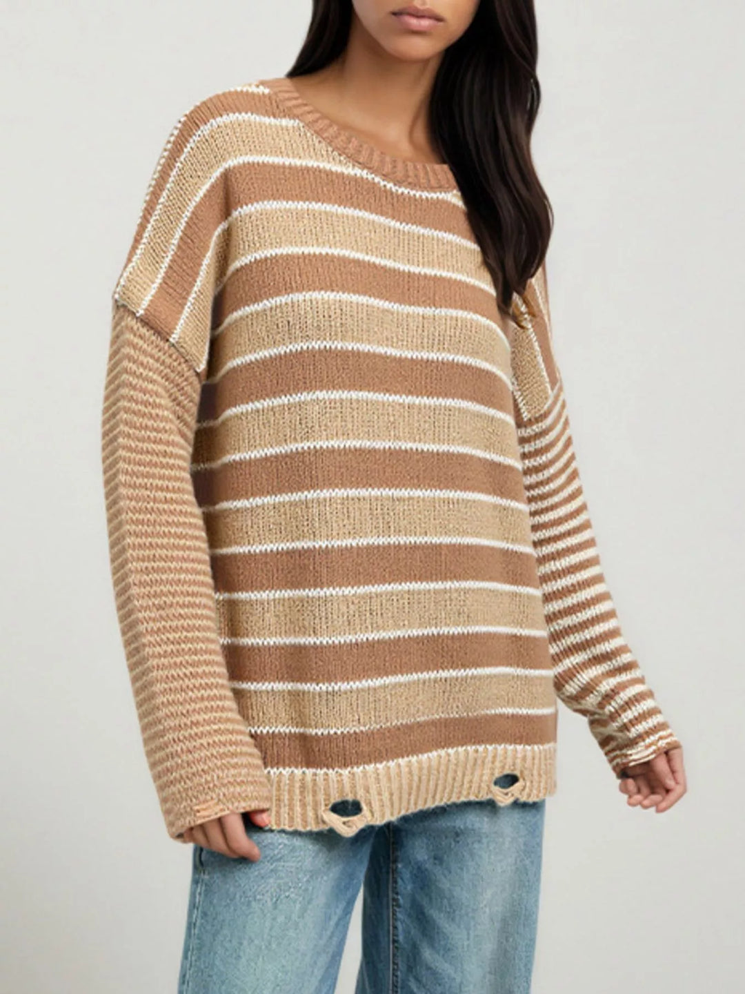 Distressed striped oversized knit sweater with raw hem