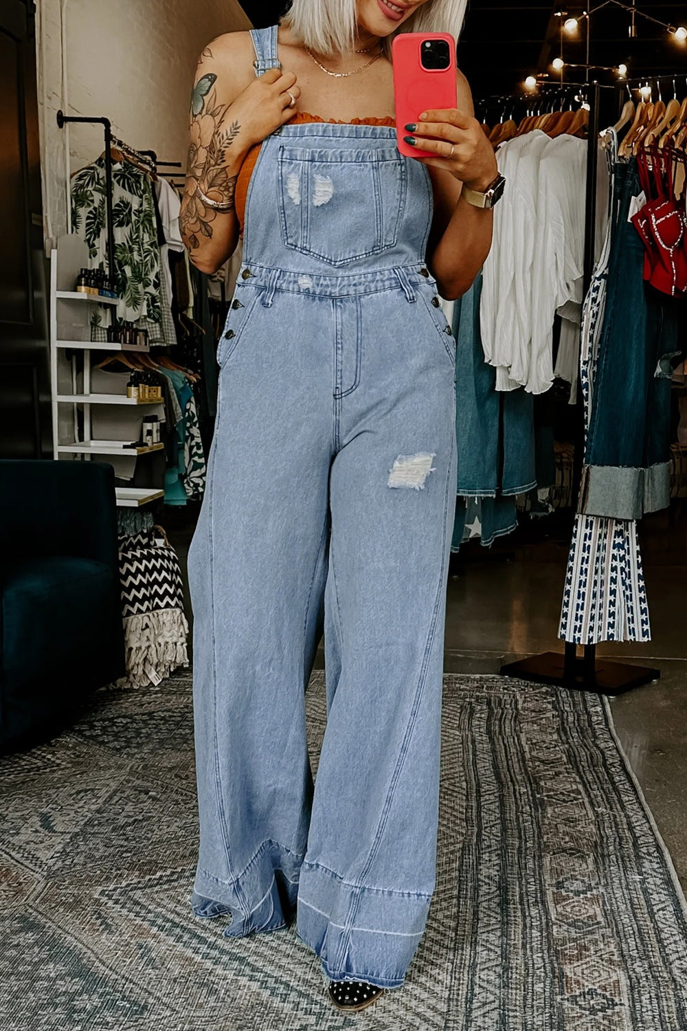 Distressed wide-leg denim overalls with adjustable straps