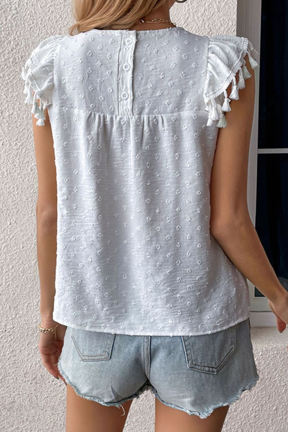 Swiss dot flutter sleeve blouse with tassel trim