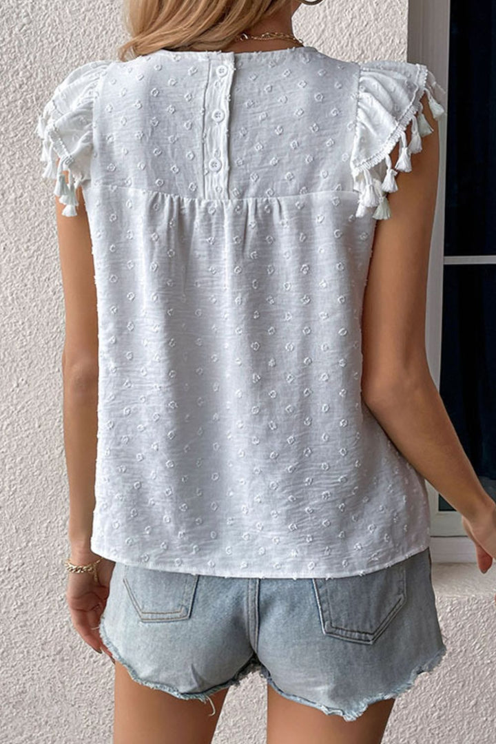 Swiss dot flutter sleeve blouse with tassel trim