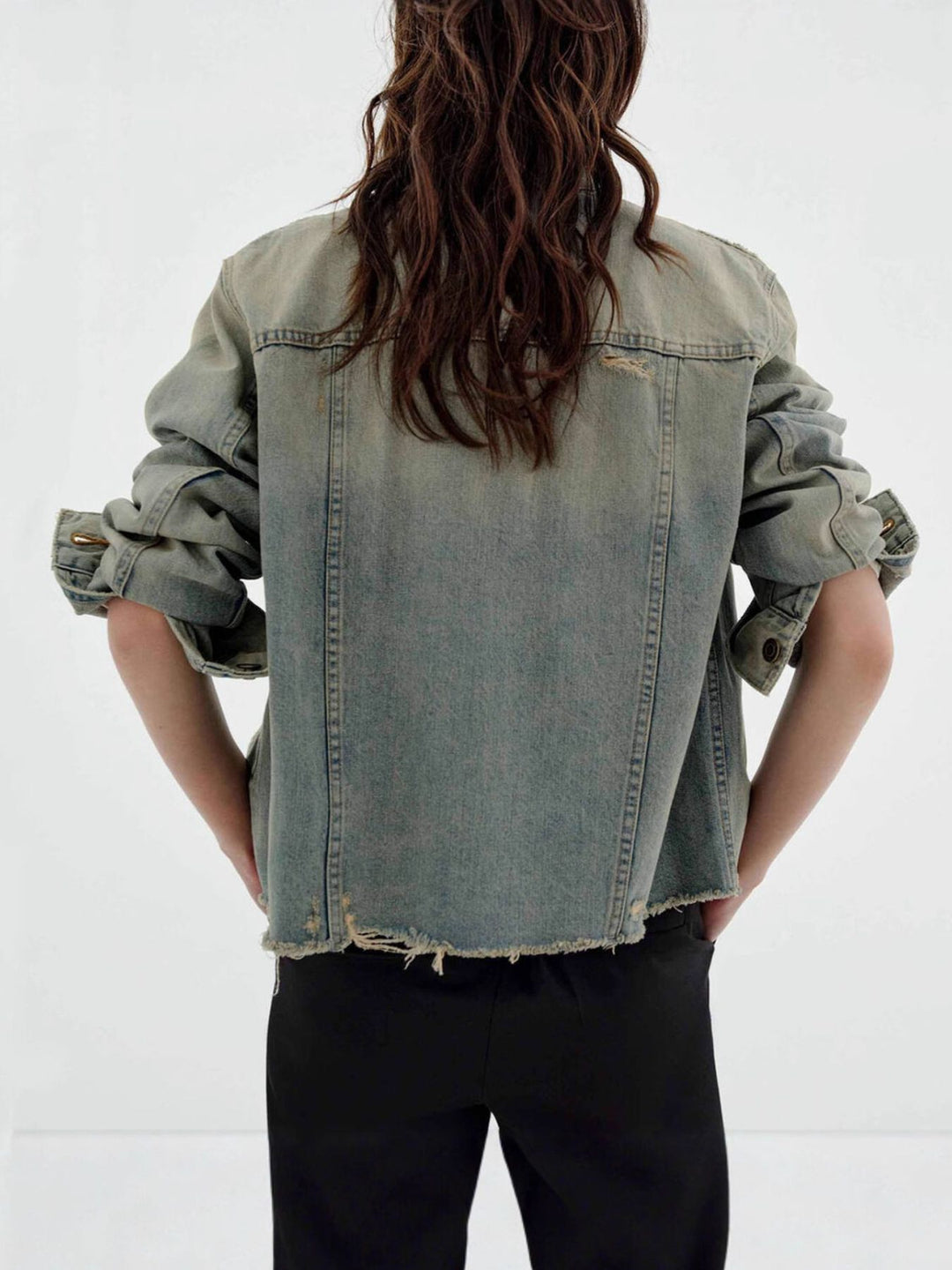 Distressed vintage wash denim jacket with raw hem