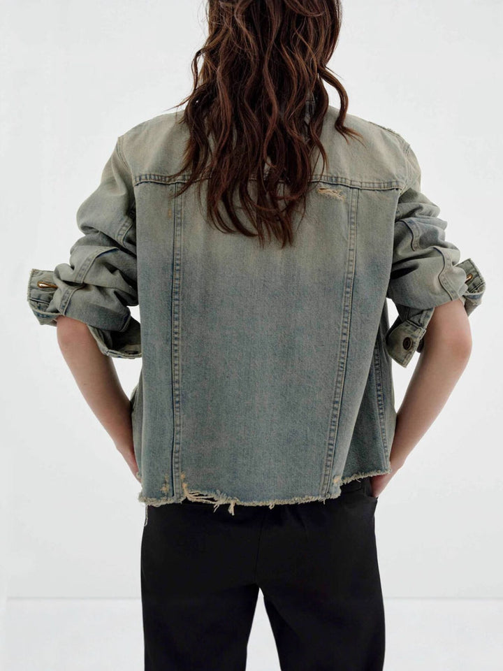 Distressed vintage wash denim jacket with raw hem