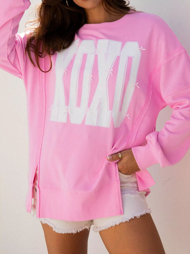 Oversized XOXO graphic sweatshirt with exposed seams and bows