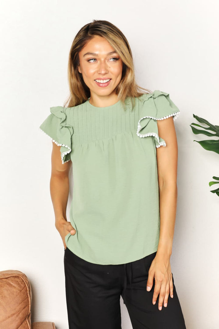 Light Green Pintuck yoke flutter sleeve blouse with pom-pom trim