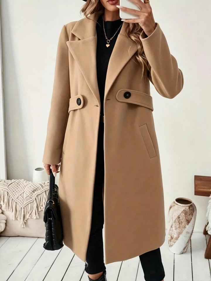 Longline notch lapel coat with single-button waist tab