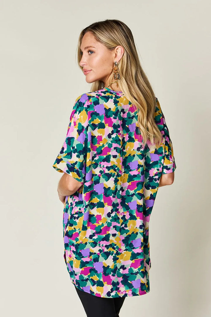 Abstract print v-neck tunic top with flutter sleeves and side slits