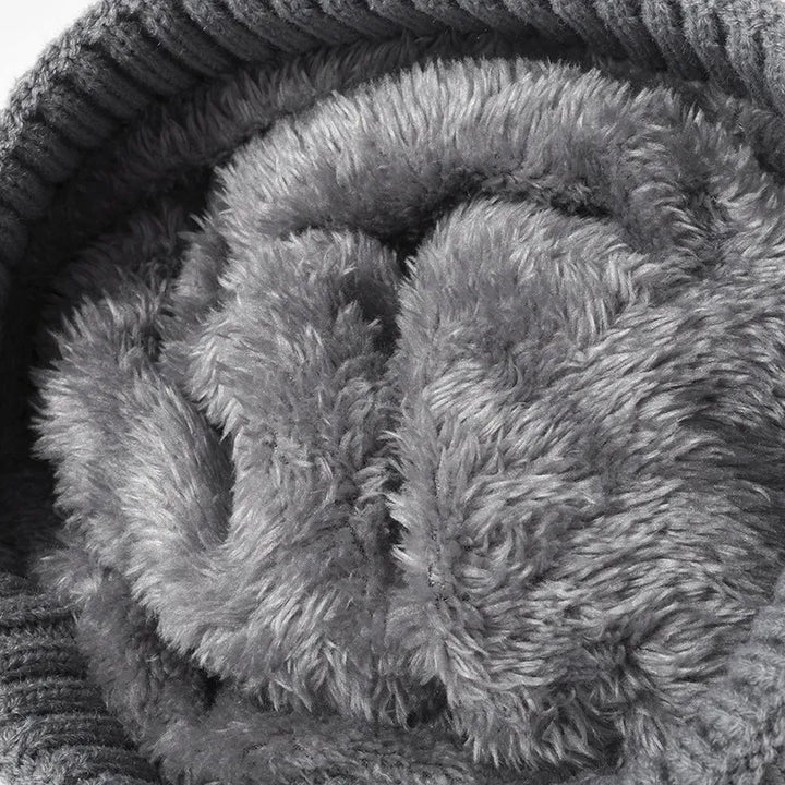 Cable knit beanie with faux fur pompom and ribbed cuff