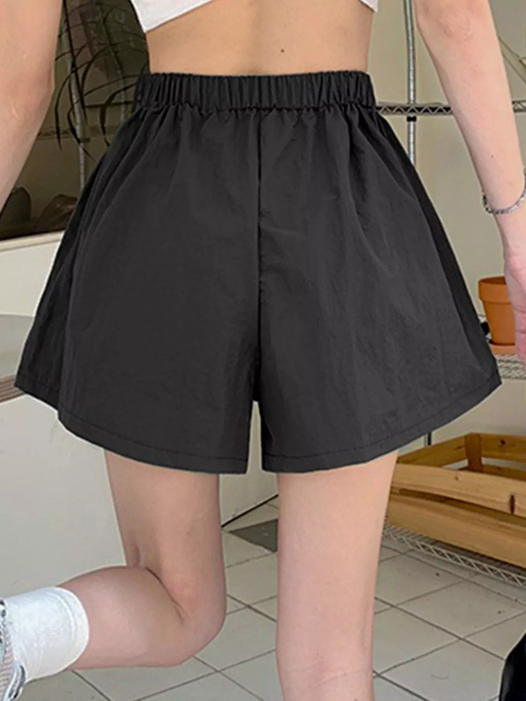 High-rise cargo shorts with zip pockets and drawstring waist