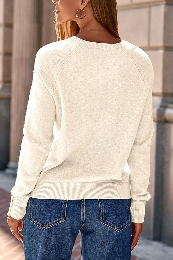 Button-cuff raglan sleeve crew neck sweater